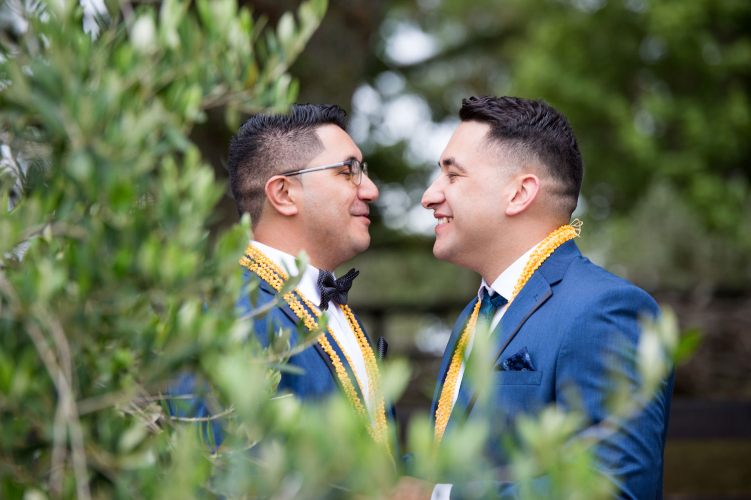 auckland wedding couple chatting behind a tree