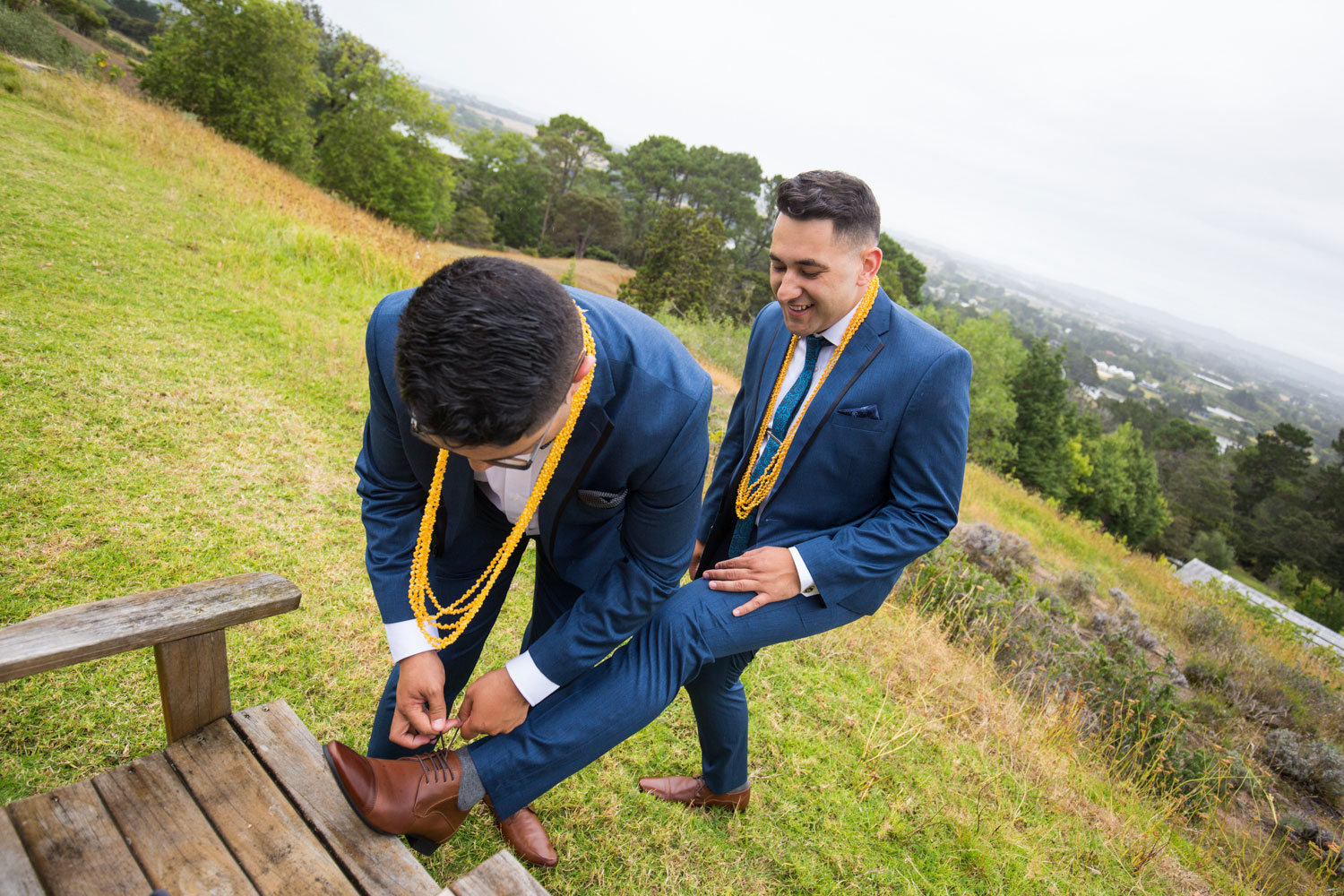 auckland wedding groom helping with shoes