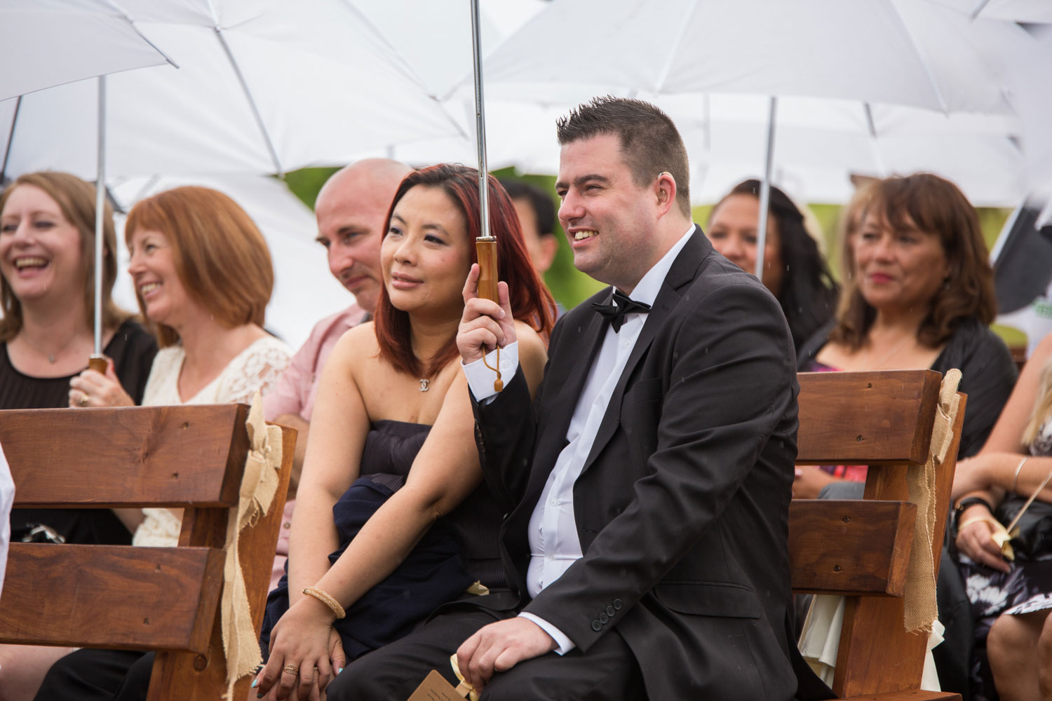 gracehill auckland wedding guests holding an umbrella