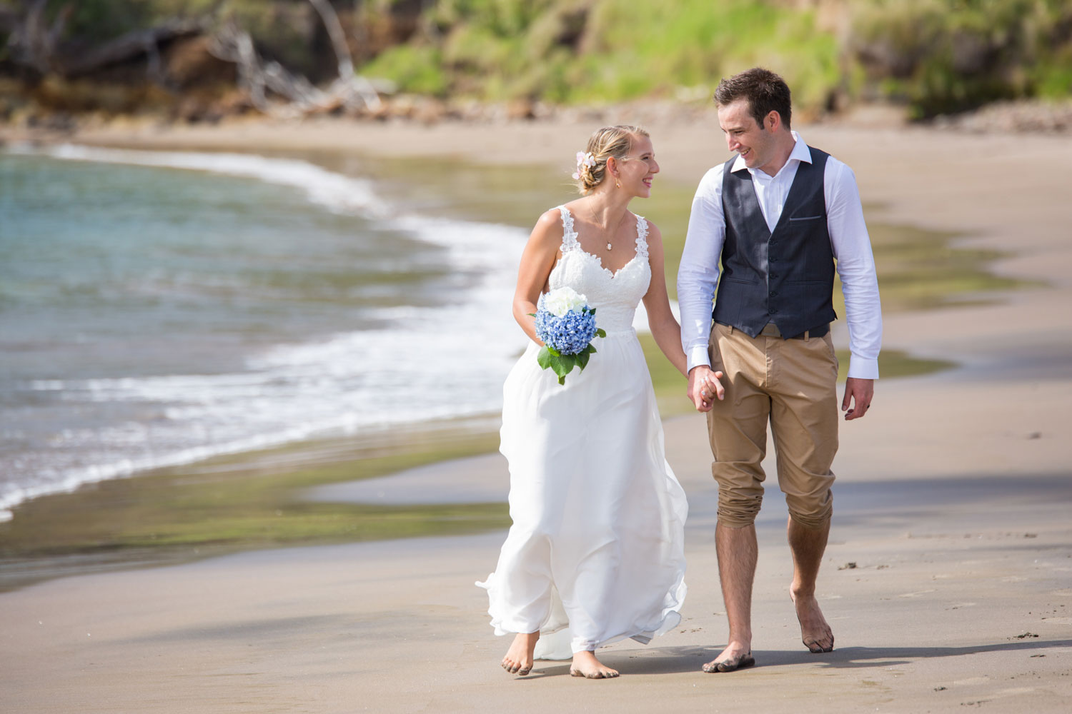 beach wedding couple strolling on beach