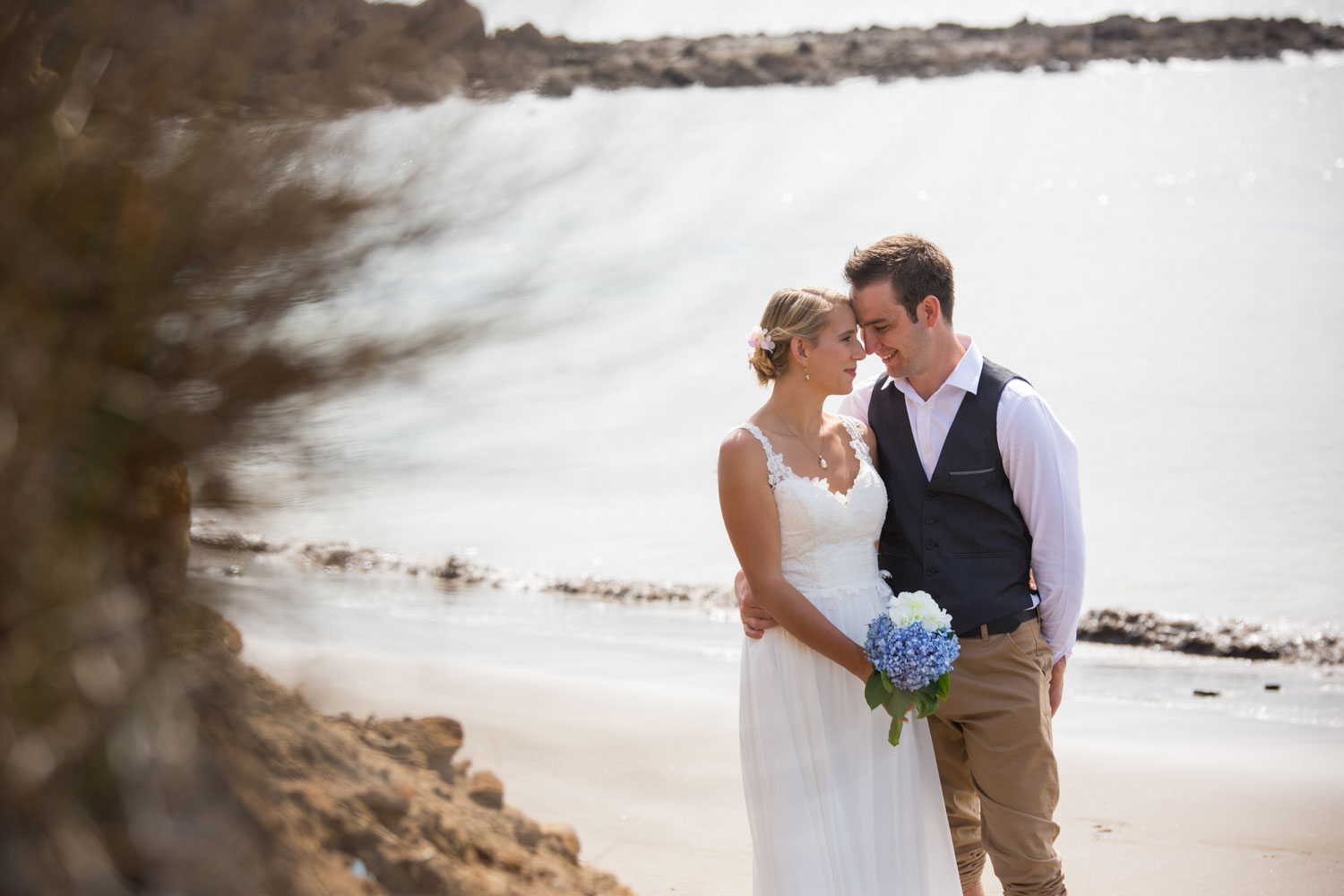 beach wedding couple forehead to forehead