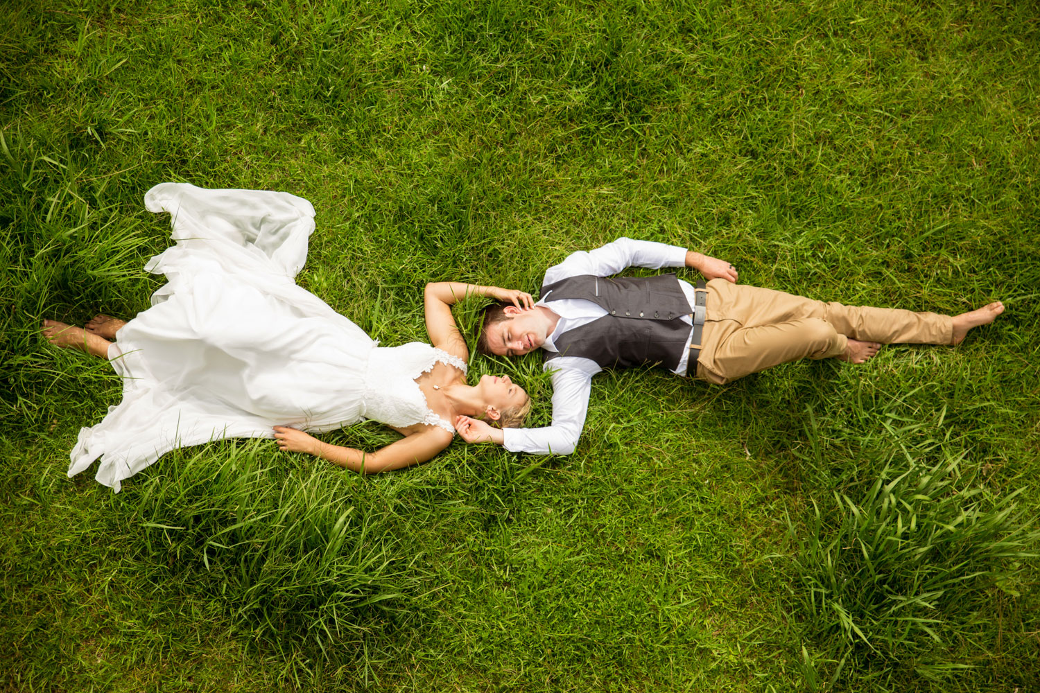 new zealand wedding couple laying on grass