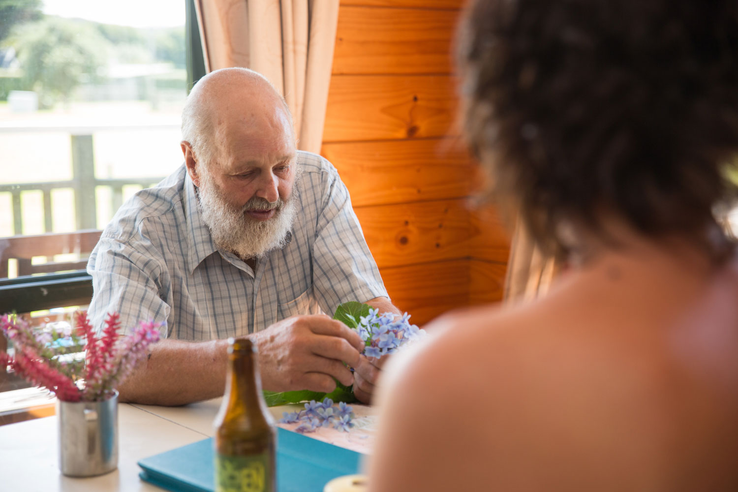 new zealand wedding man helping flowers