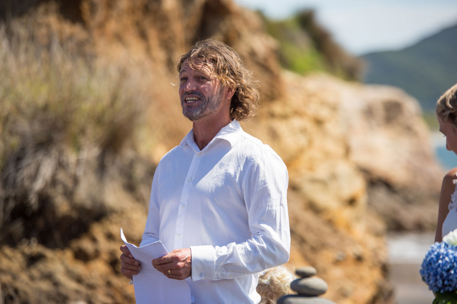 beach wedding photos celebrant talking