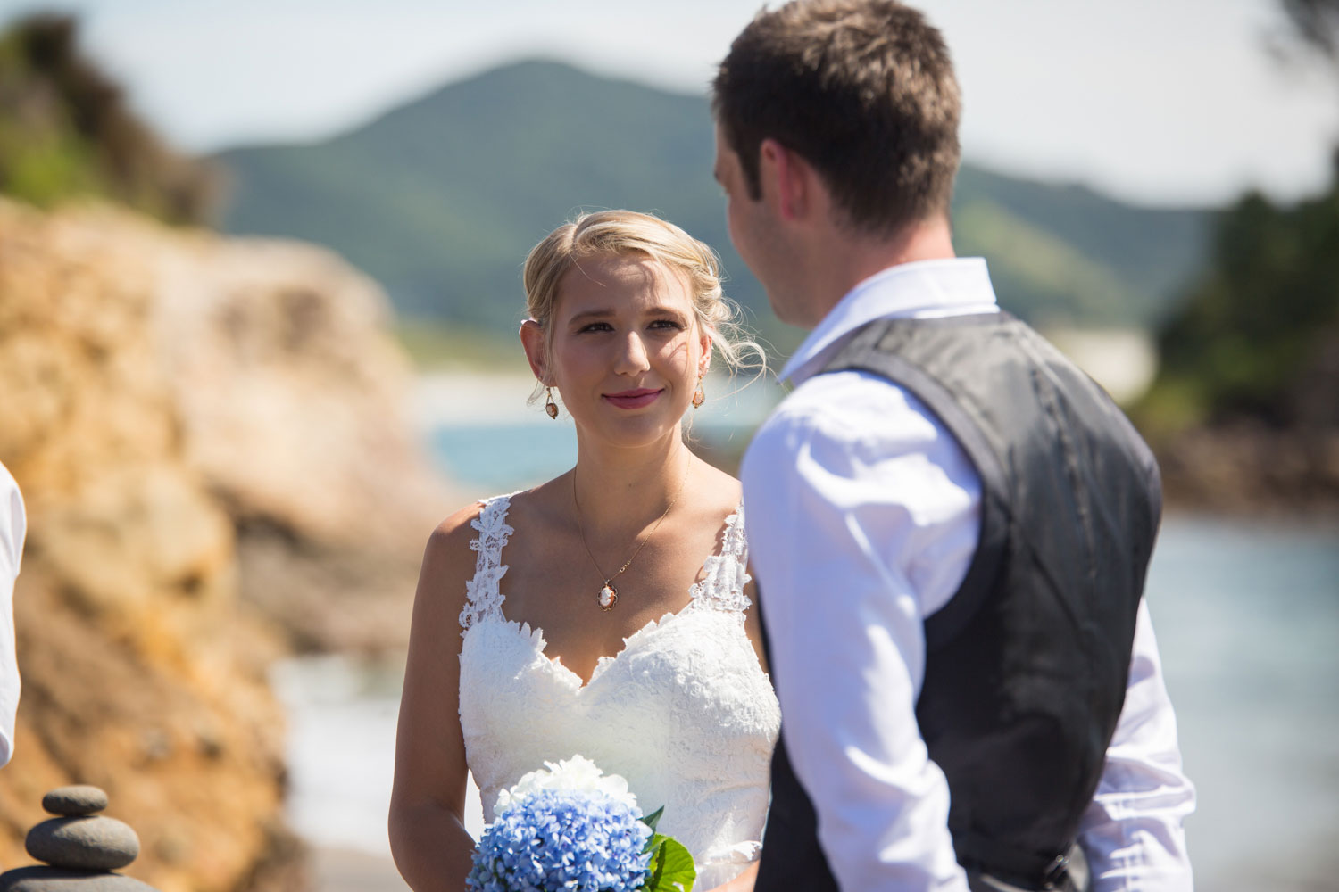 beach wedding photos bride looking at groom