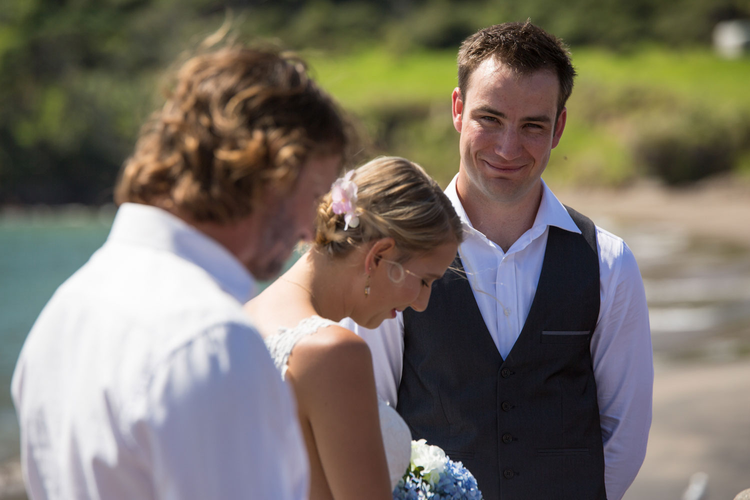 beach wedding photos groom looking at celebrant