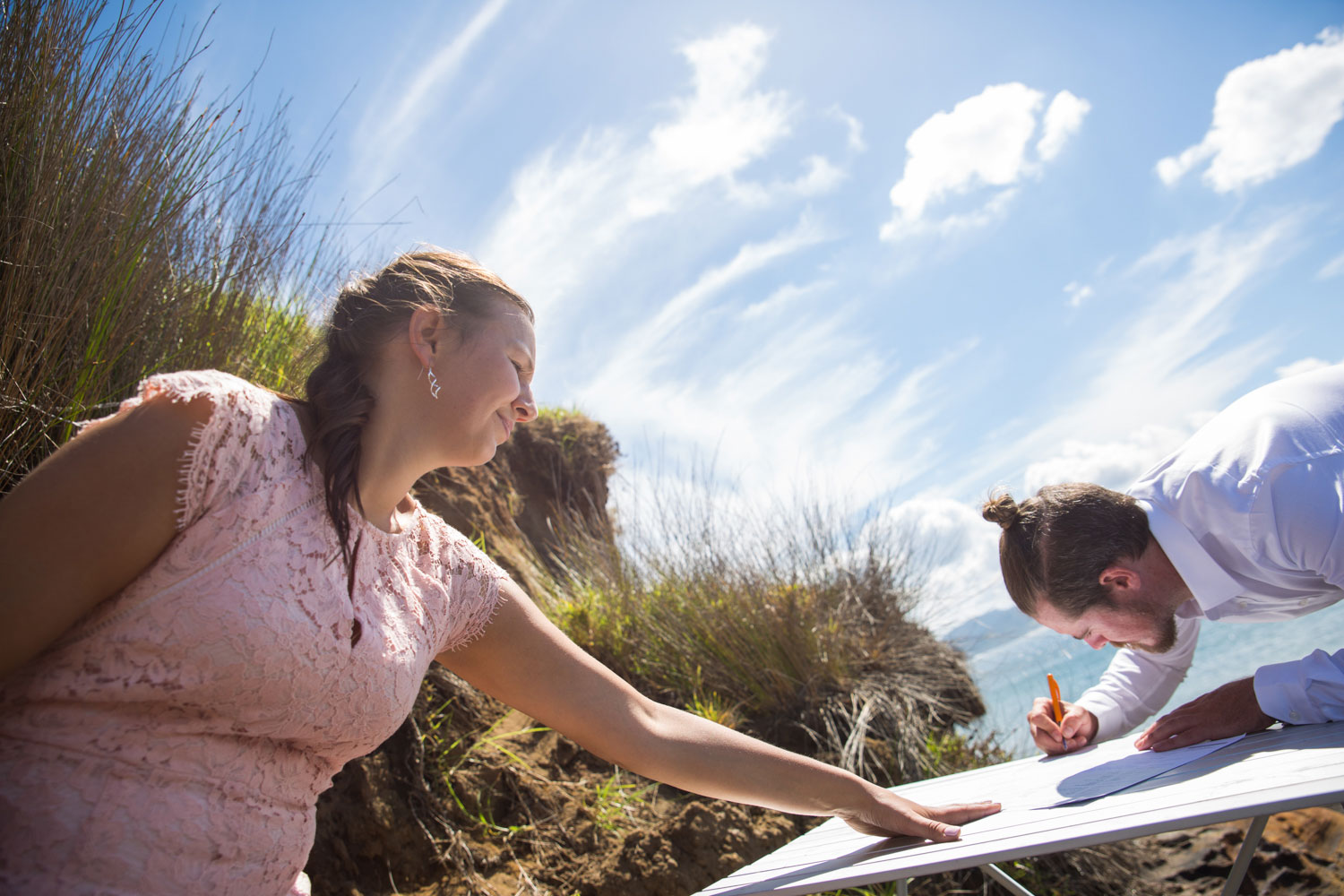 beach wedding witnesses sign papers