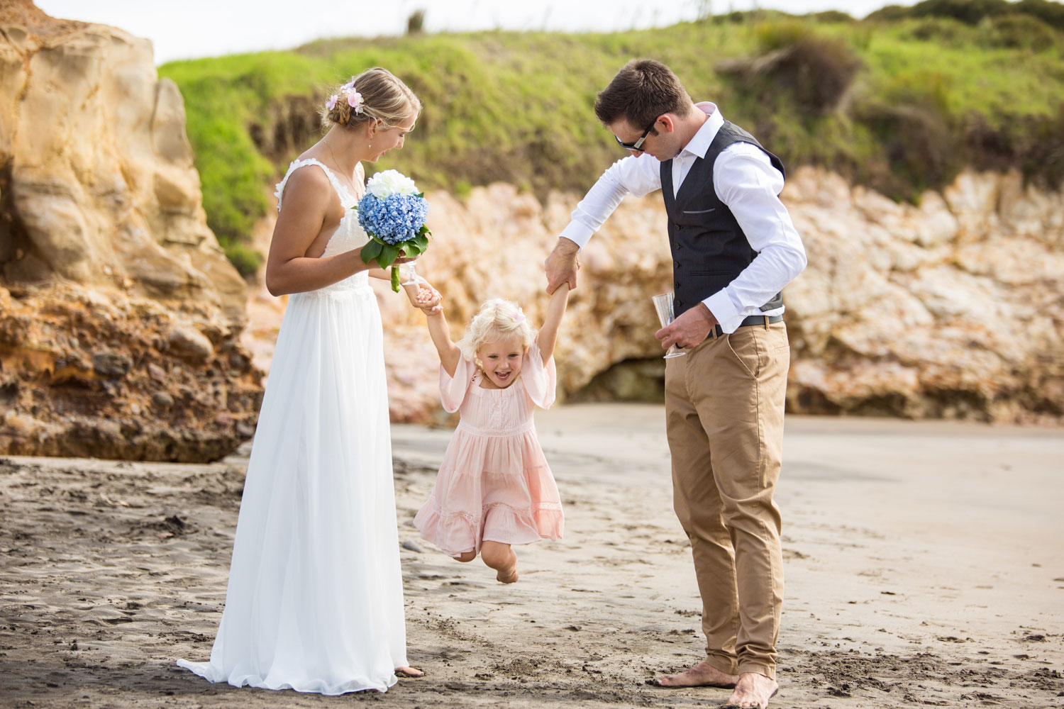 beach wedding couple and flower girl