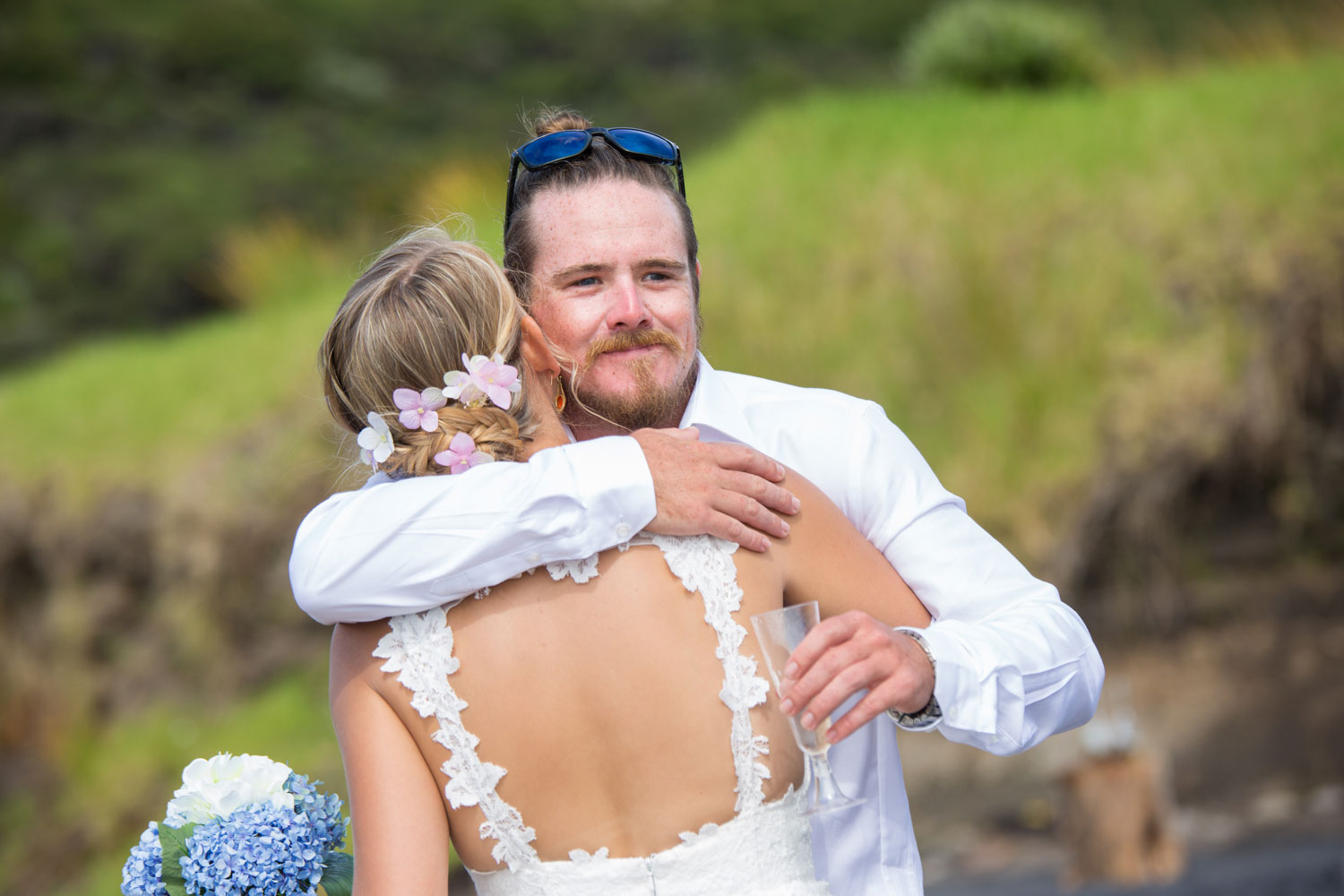 beach wedding best man hugging bride