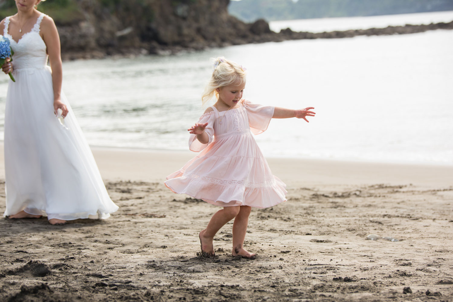 beach wedding flower girl playing