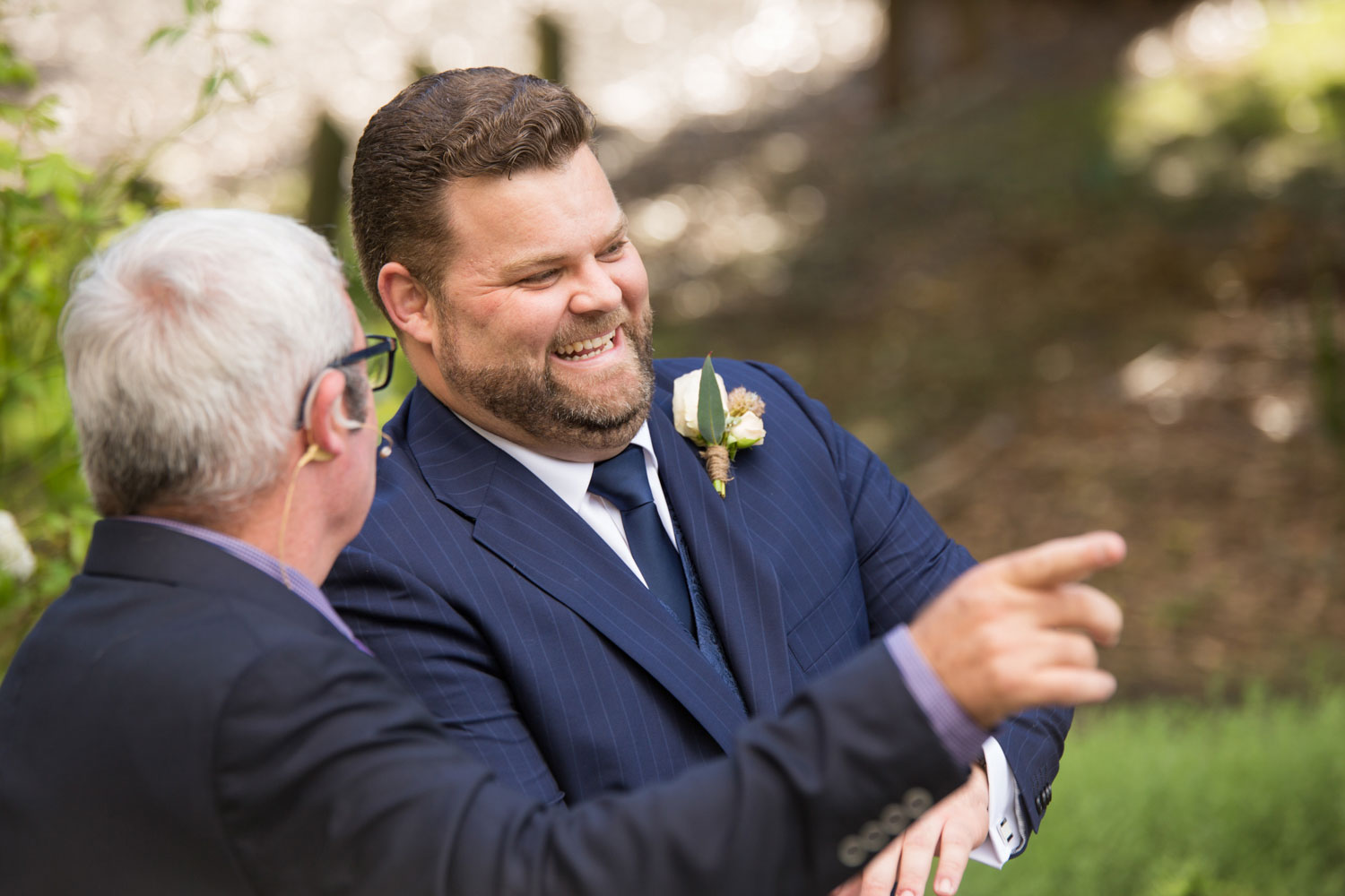 wedding photographer auckland groom talking to celebrant