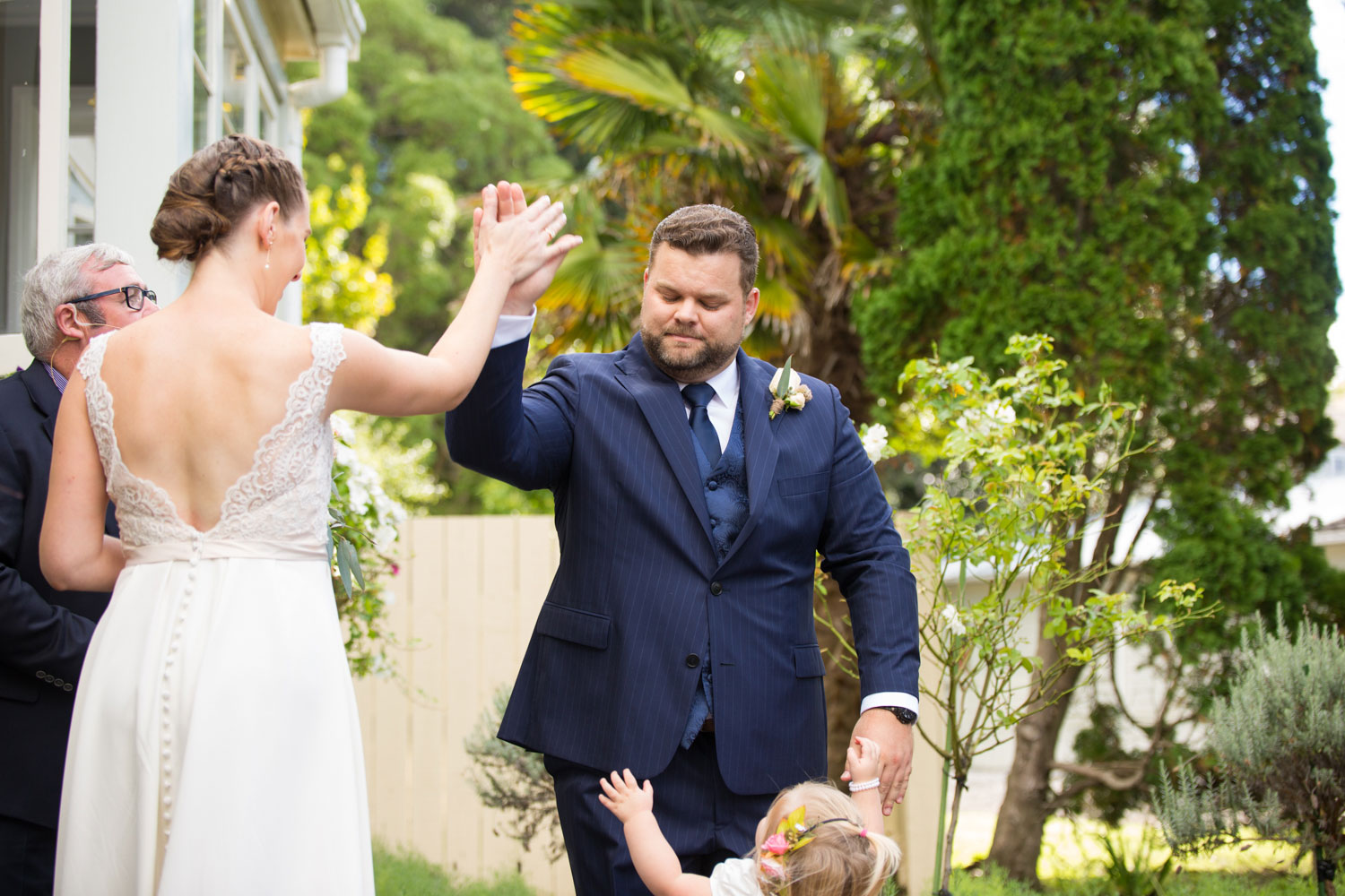 wedding photographer auckland groom and bride high five