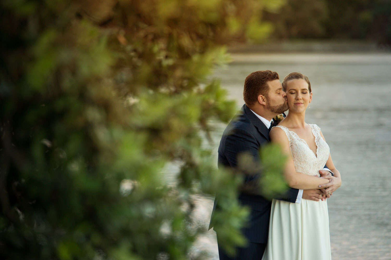 wedding photographer auckland groom kisses bride
