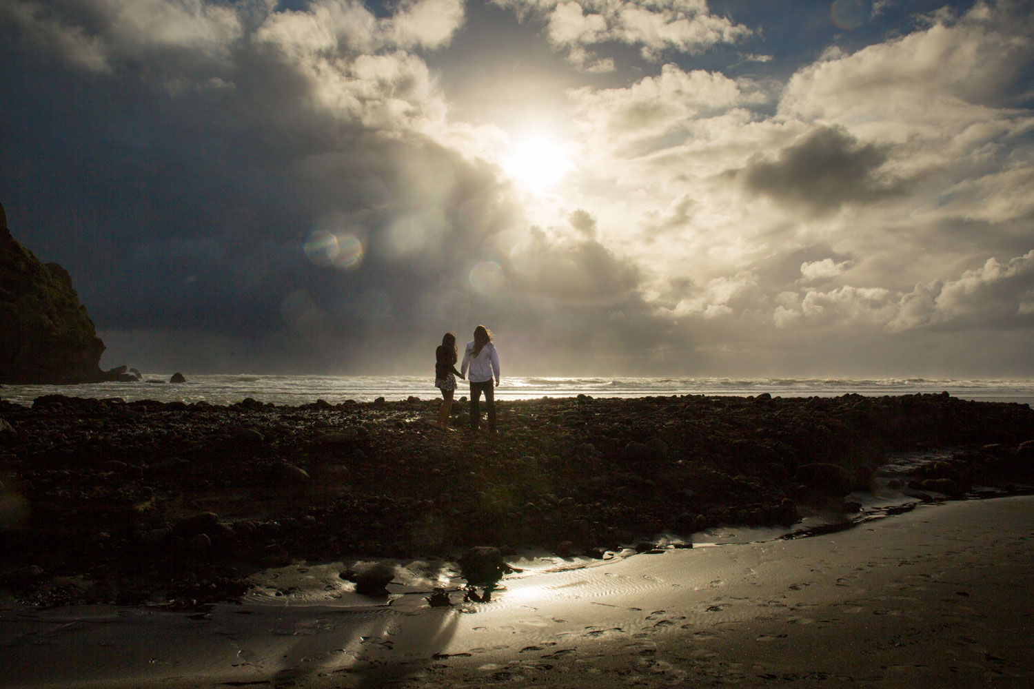 piha beach engagement photos silhouette of couple