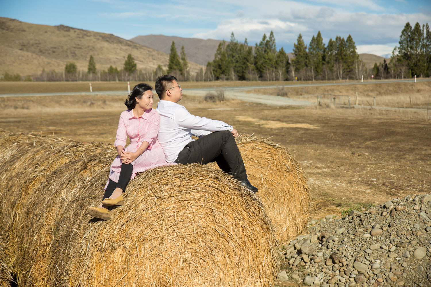 south island prewedding couple on hay bales