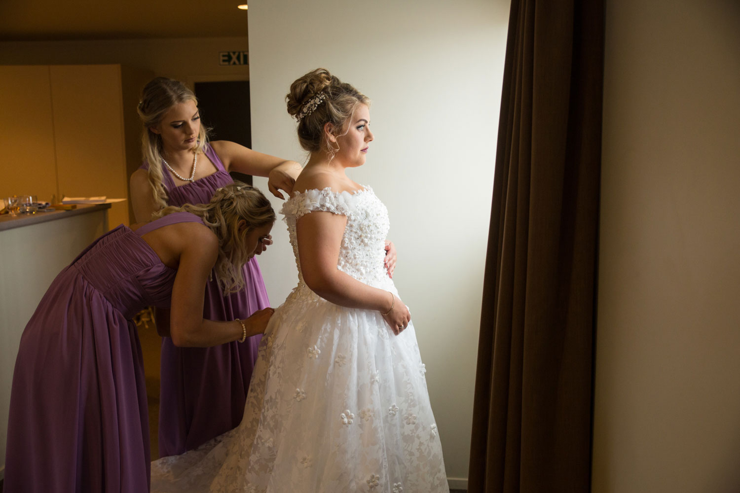 hamilton wedding bride putting on her dress