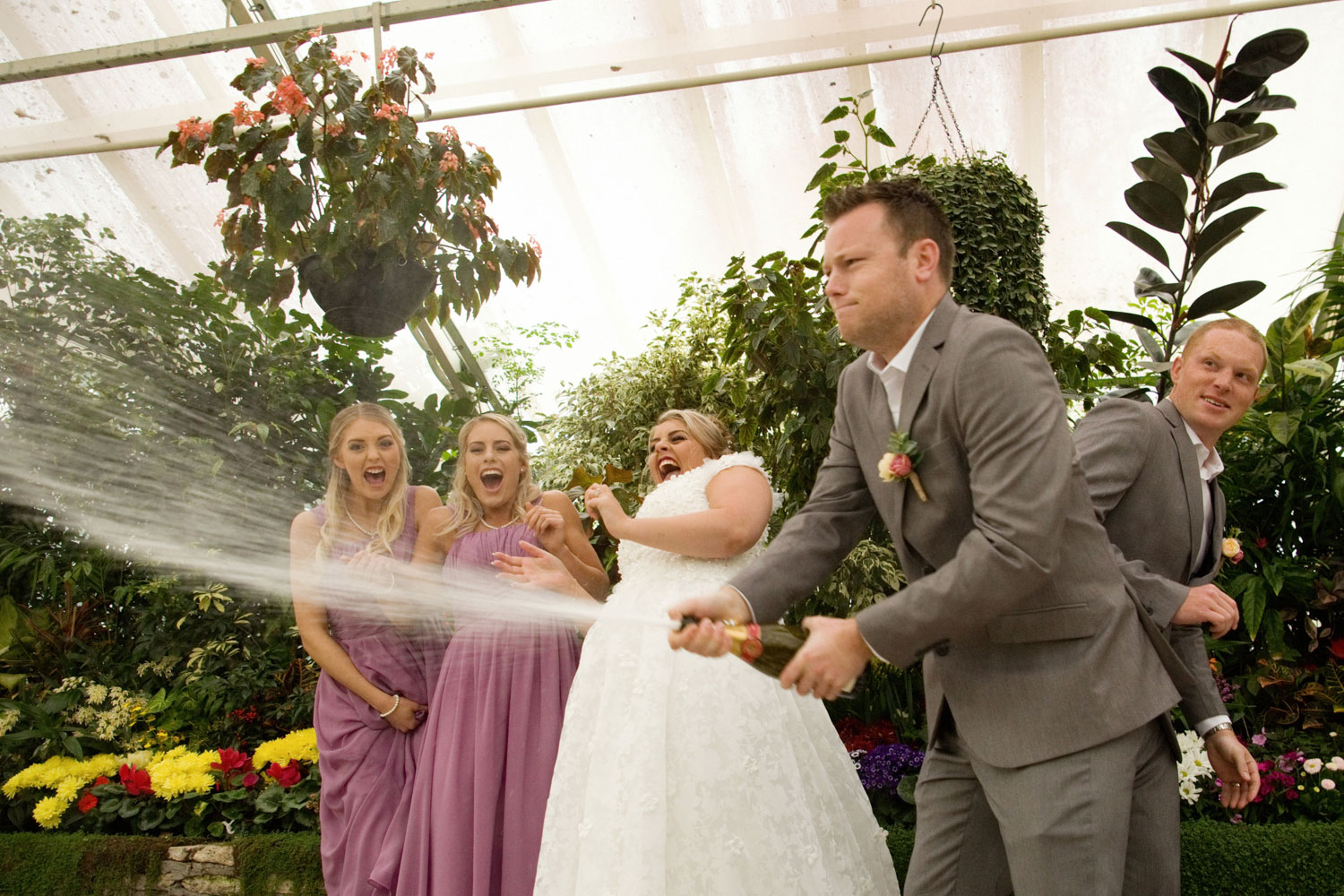 hamilton wedding groomsmen popping champagne