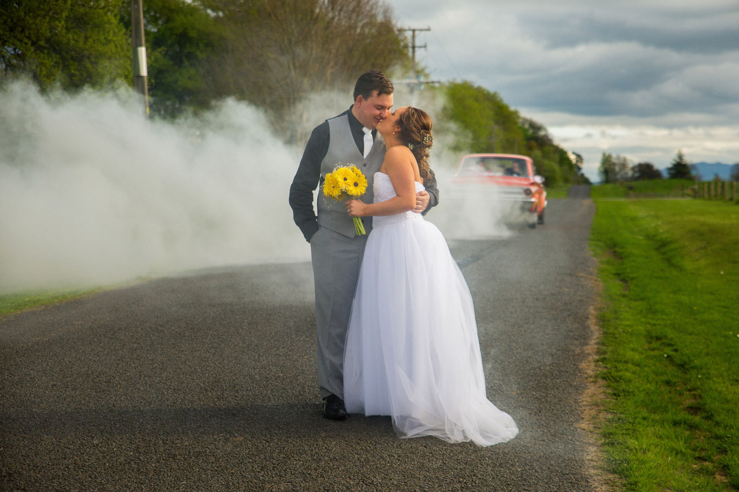 the red barn waikato wedding couple and car burnout