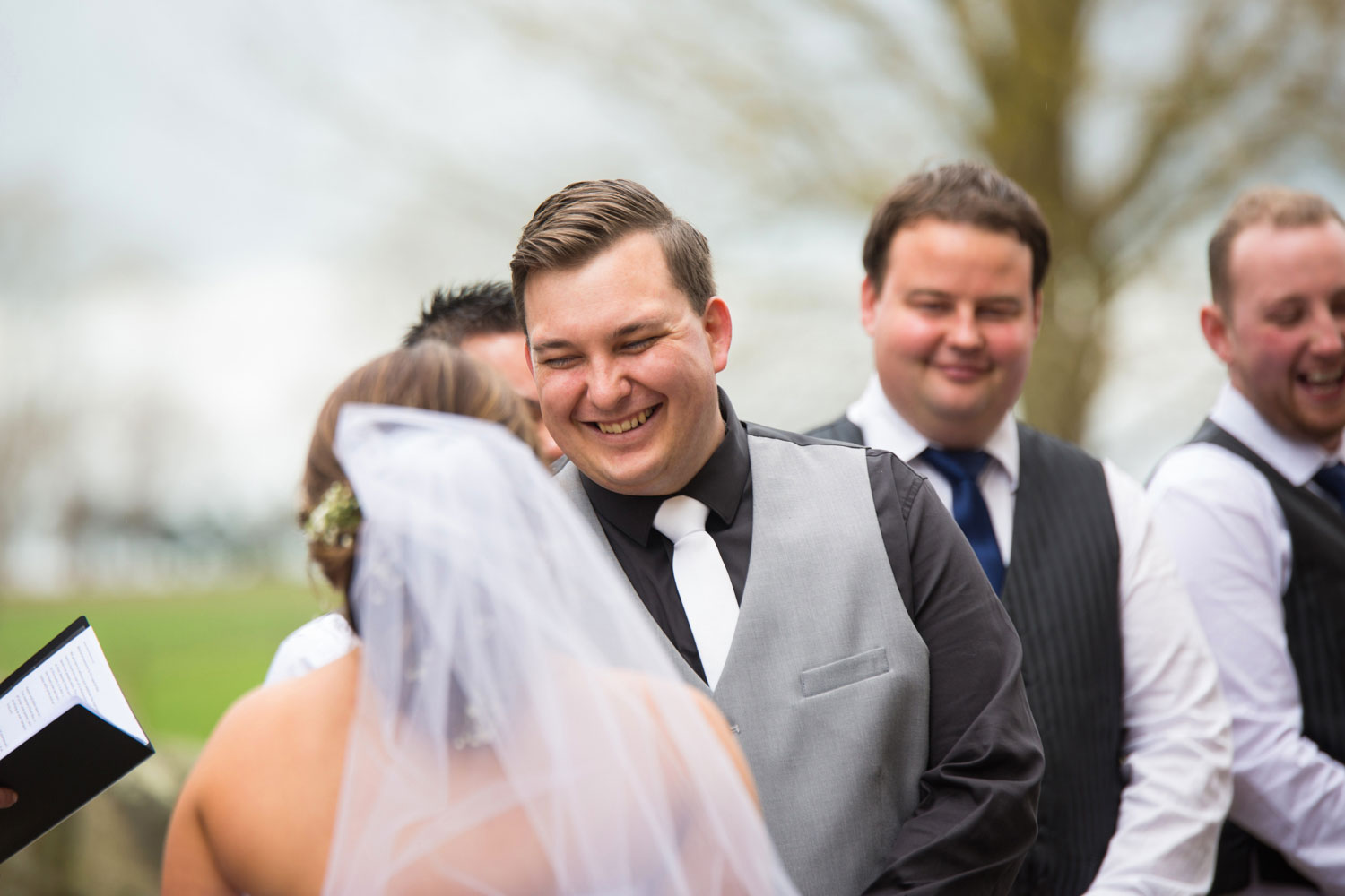 the red barn waikato wedding ceremony groom laughing