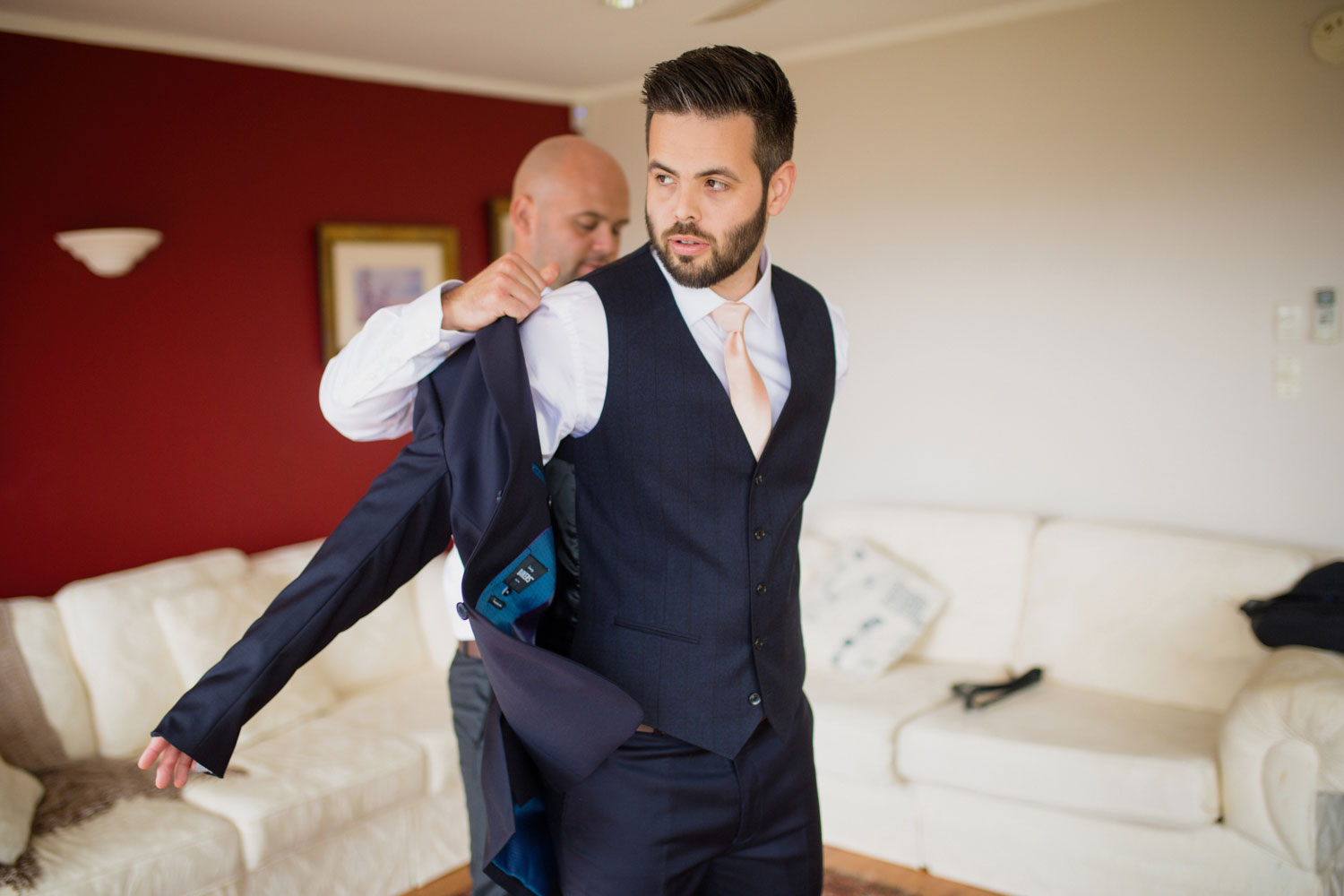 groom putting on suit