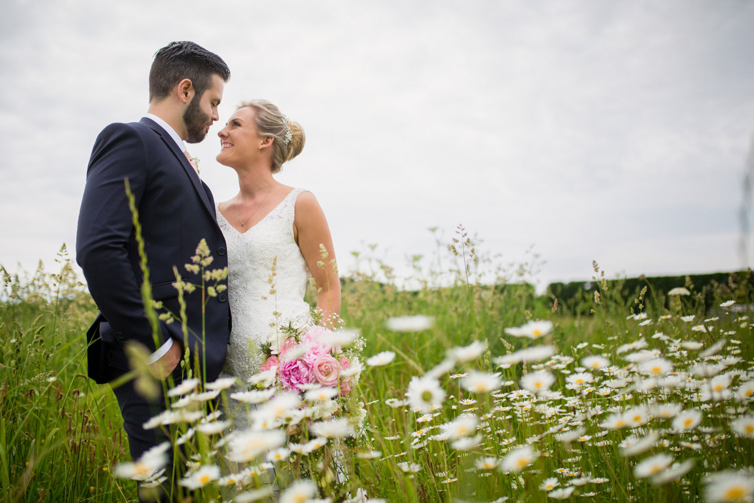 bride and groom in a field of flowers