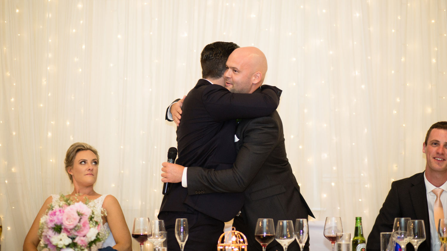 brother hug groom