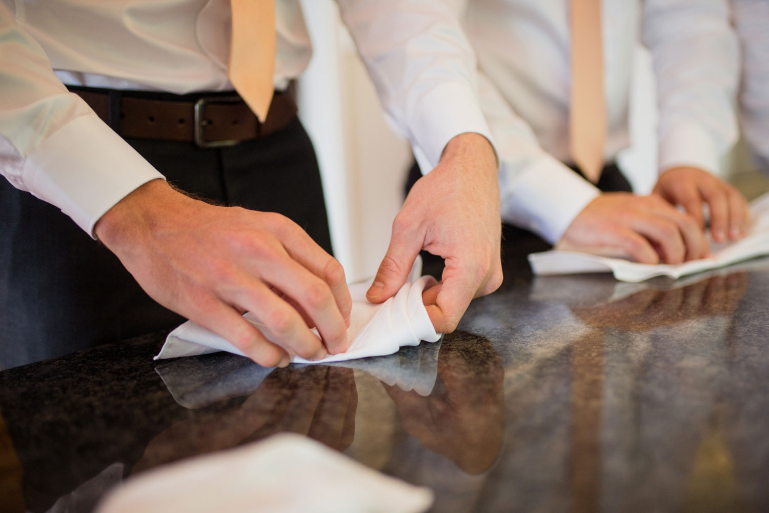 groomsmen folding napkin