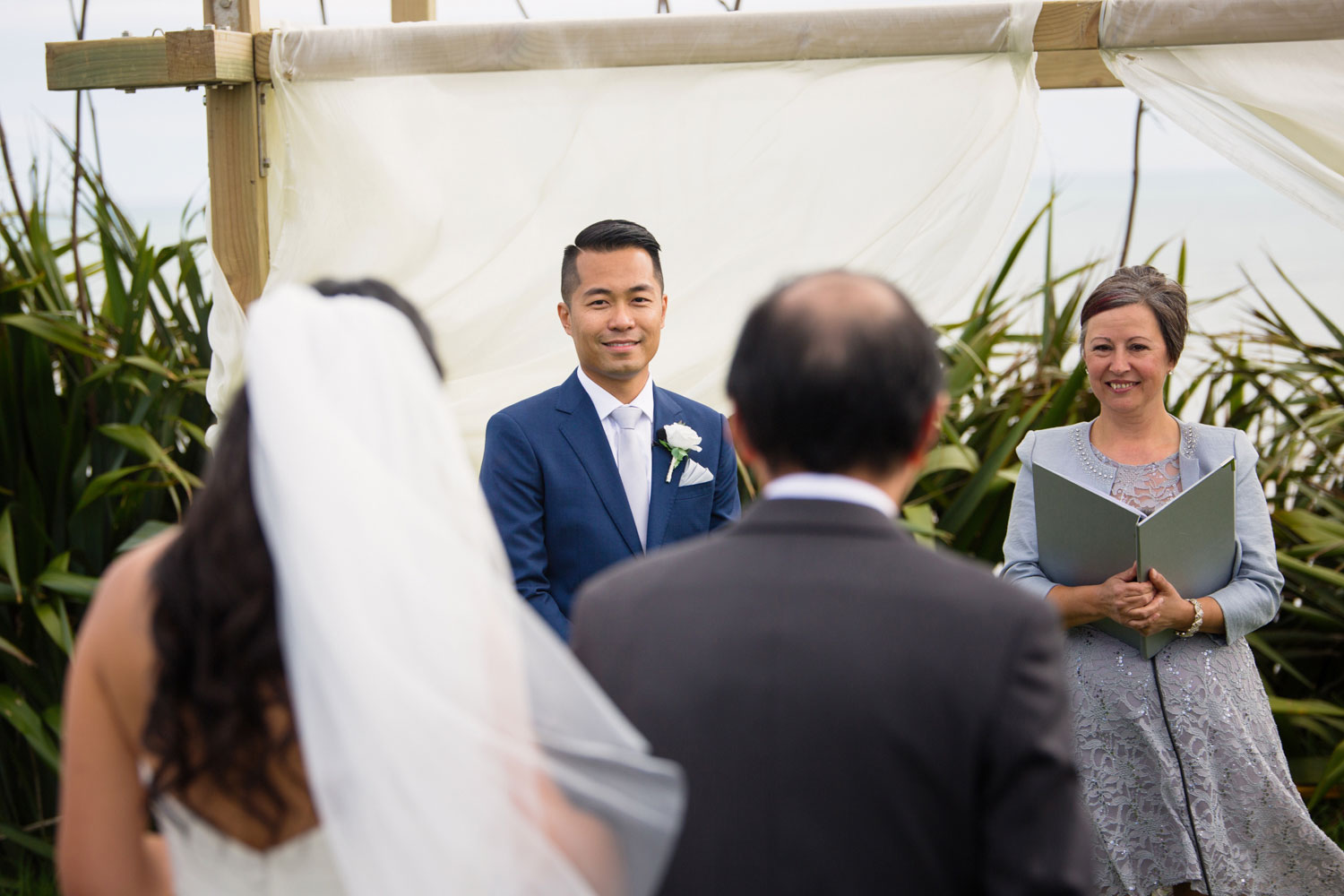 castaways waiuku wedding groom looking at bride