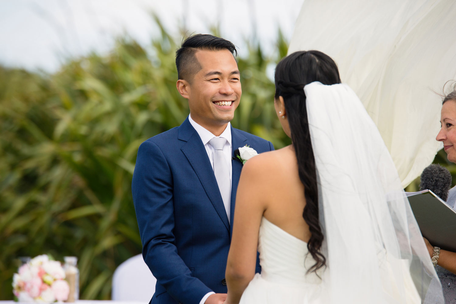 castaways waiuku wedding groom smiling at the bride