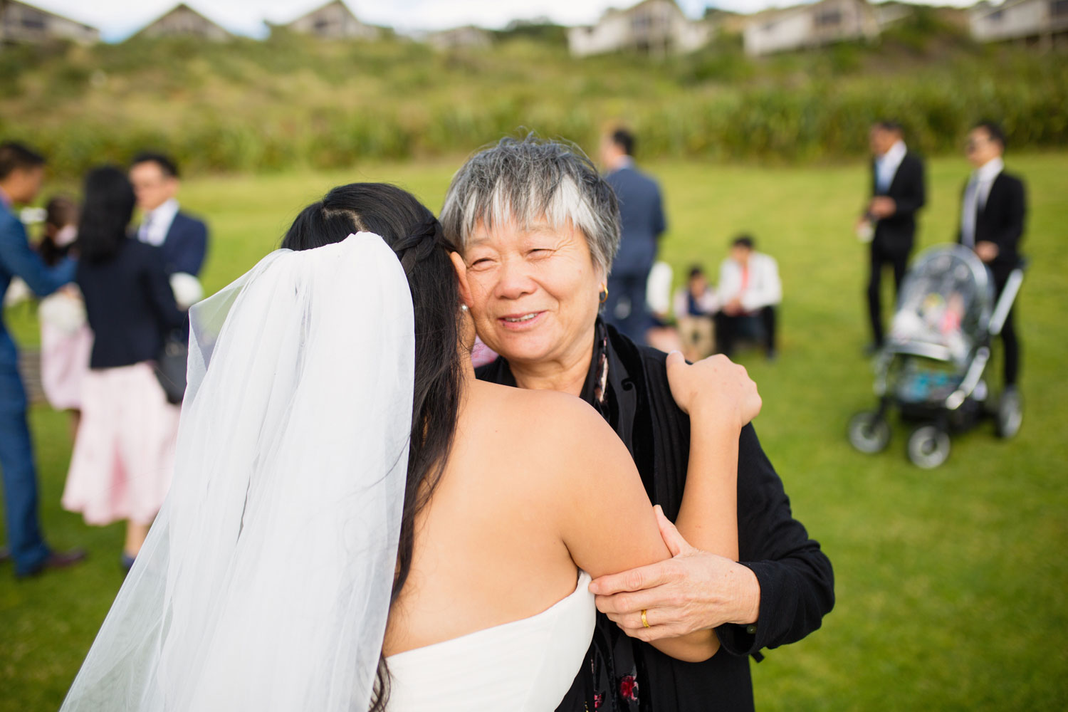 castaways waiuku wedding friend hugging bride