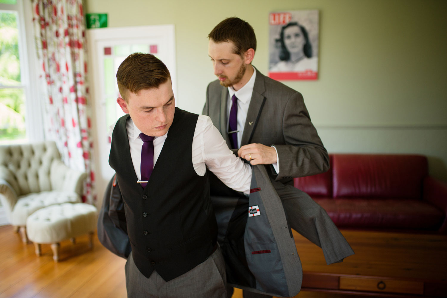 groom putting on suit