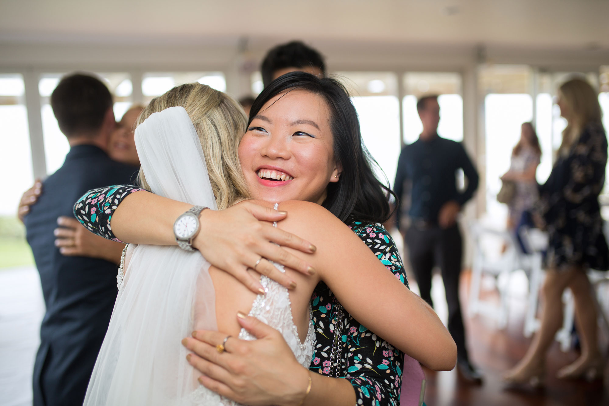 guest hugging bride