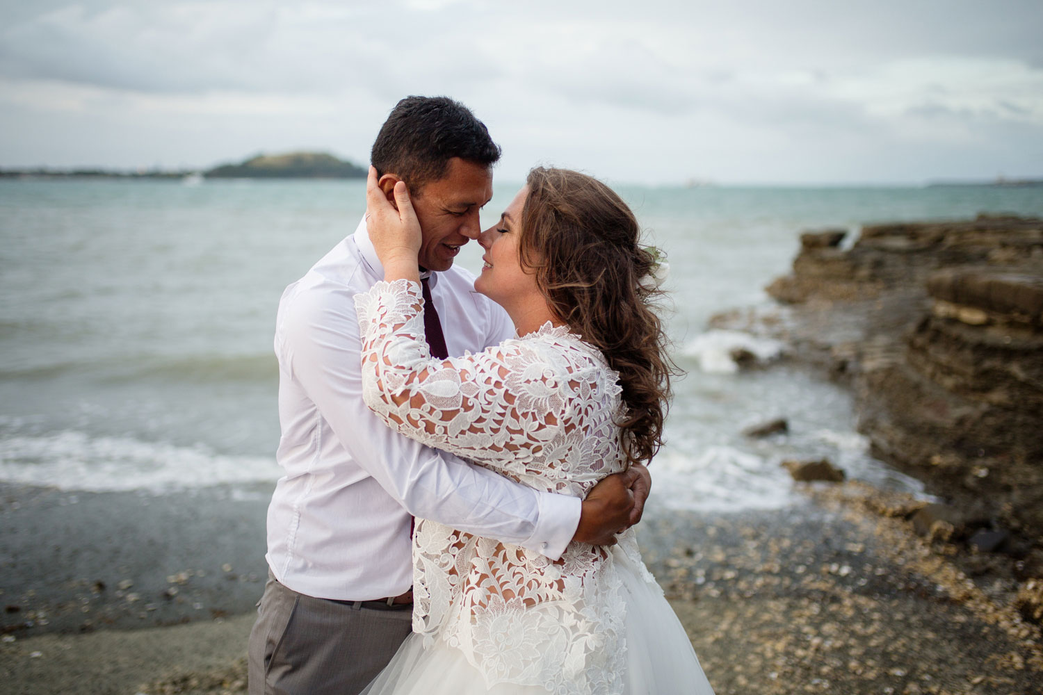 bride holding groom face