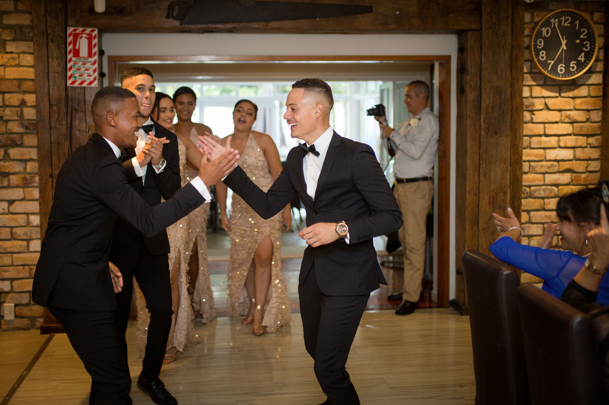 groomsmen entering reception