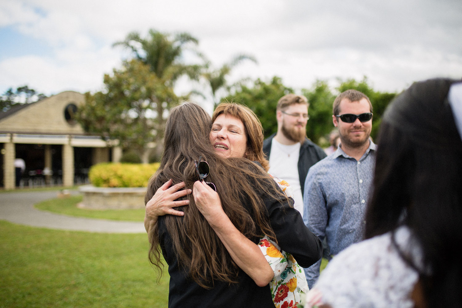 guests hugging groom