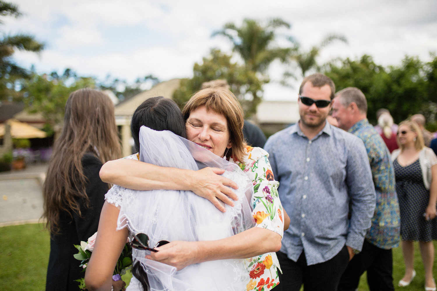 guests hugging bride