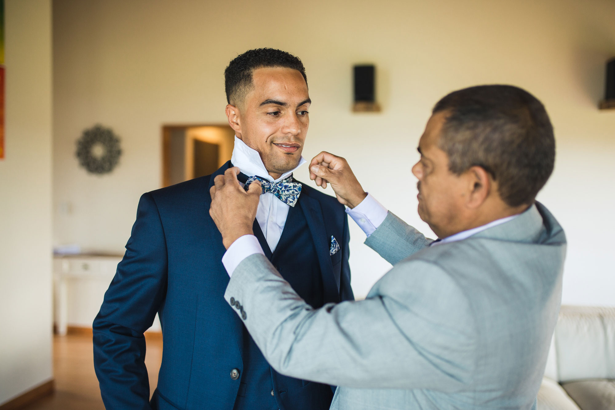 groom putting on bow tie