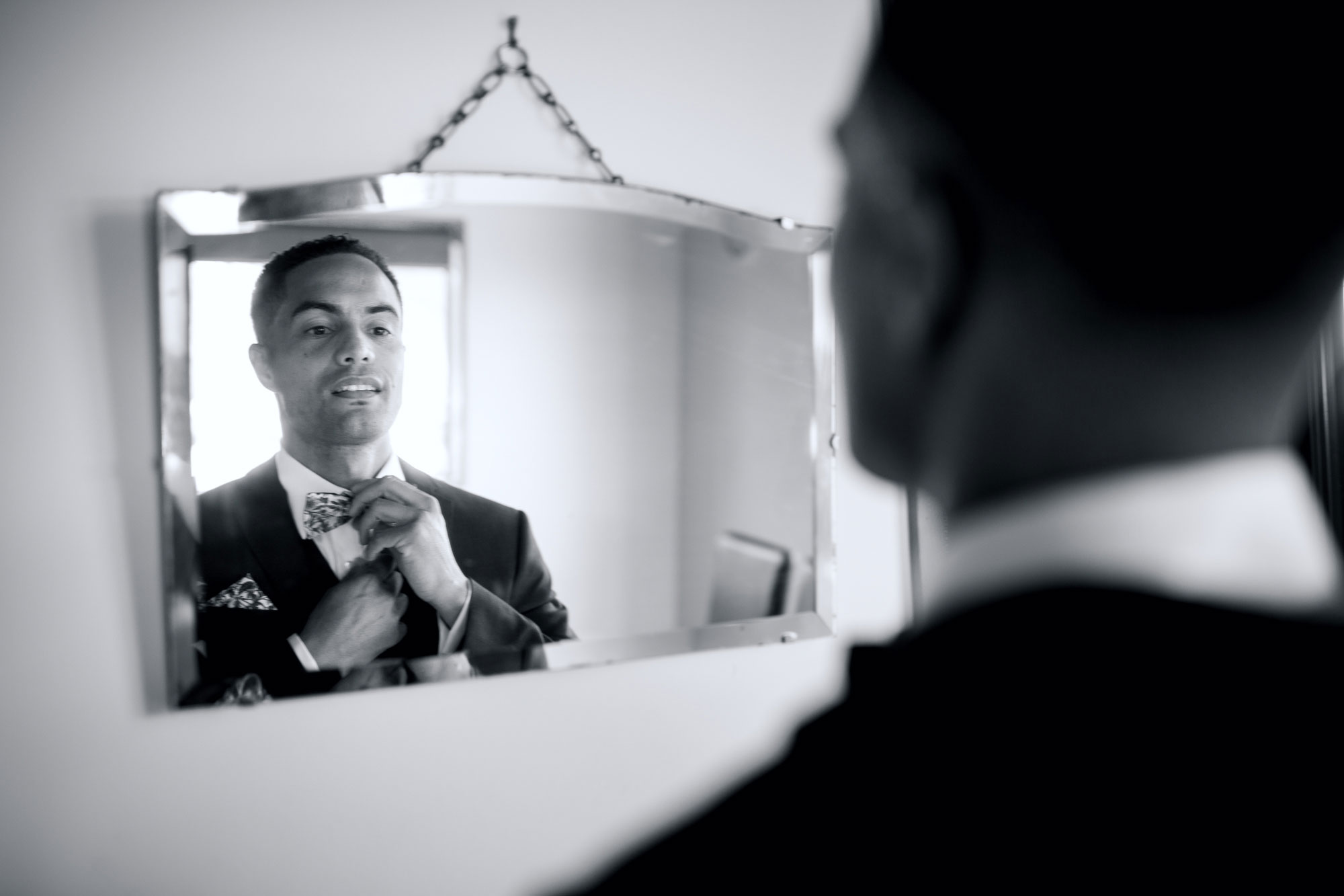 groom looking at mirror