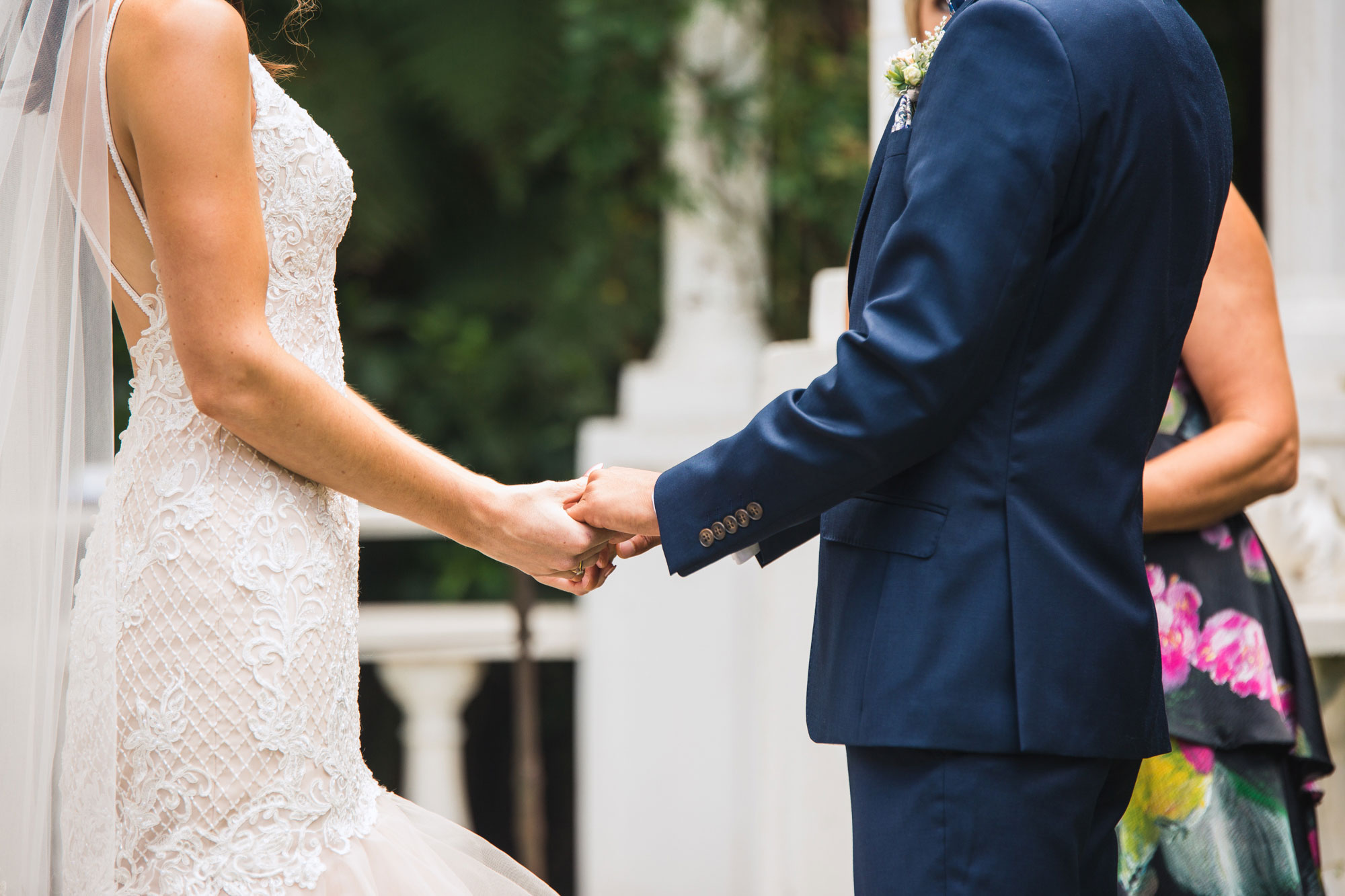 groom holding bride's hands