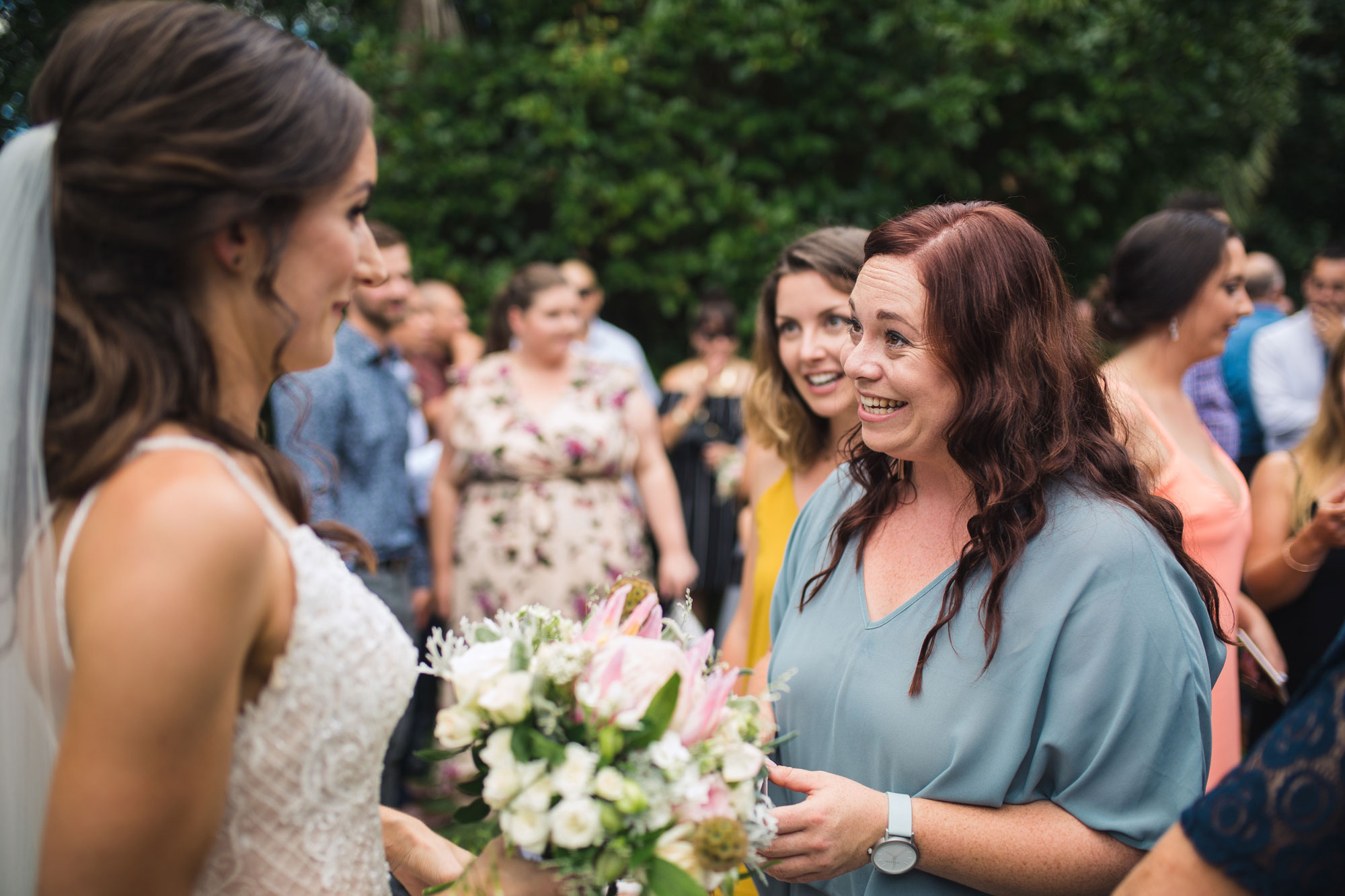 guest chatting with the bride