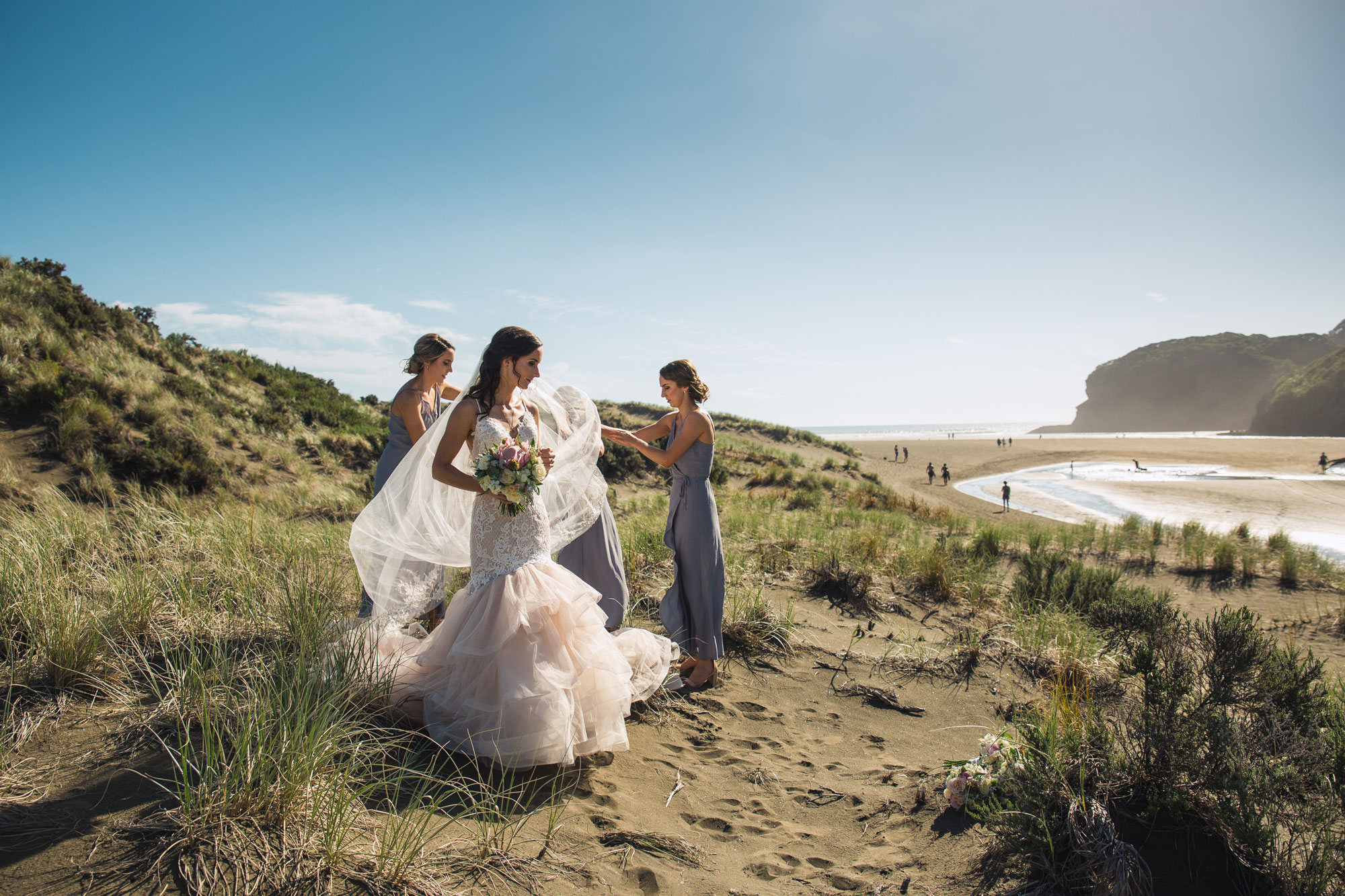 bridesmaids preparing bride's dress