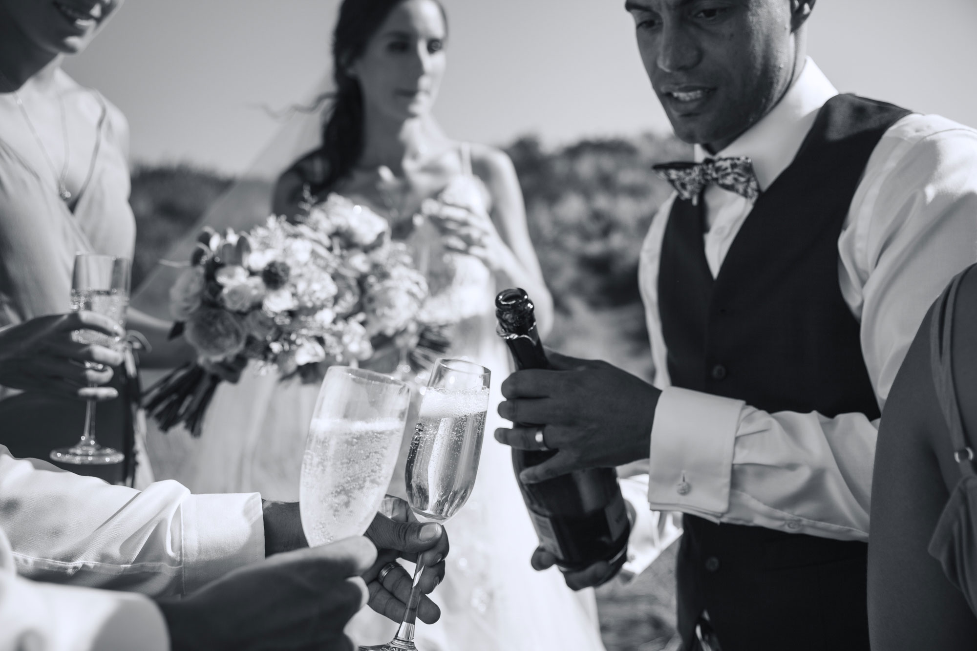 groom pouring champagne