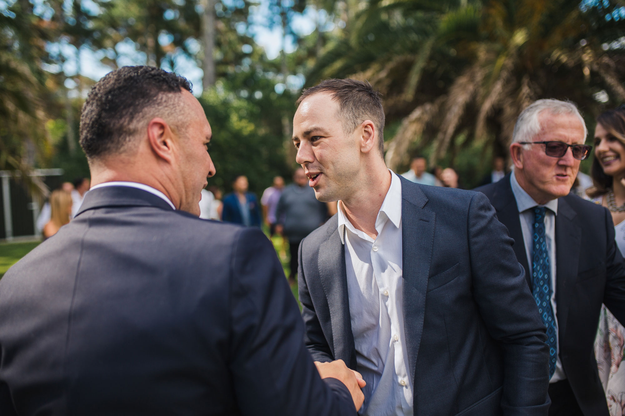 guest congratulating groom