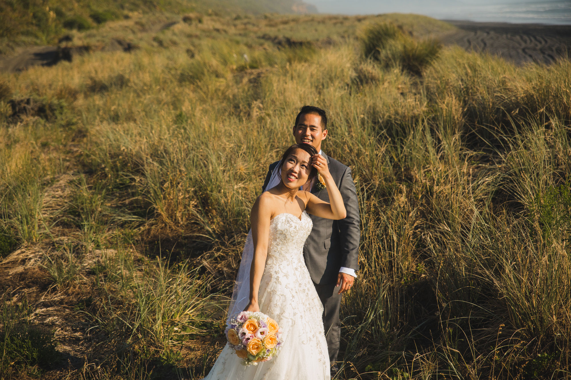 bride and groom looking at drone