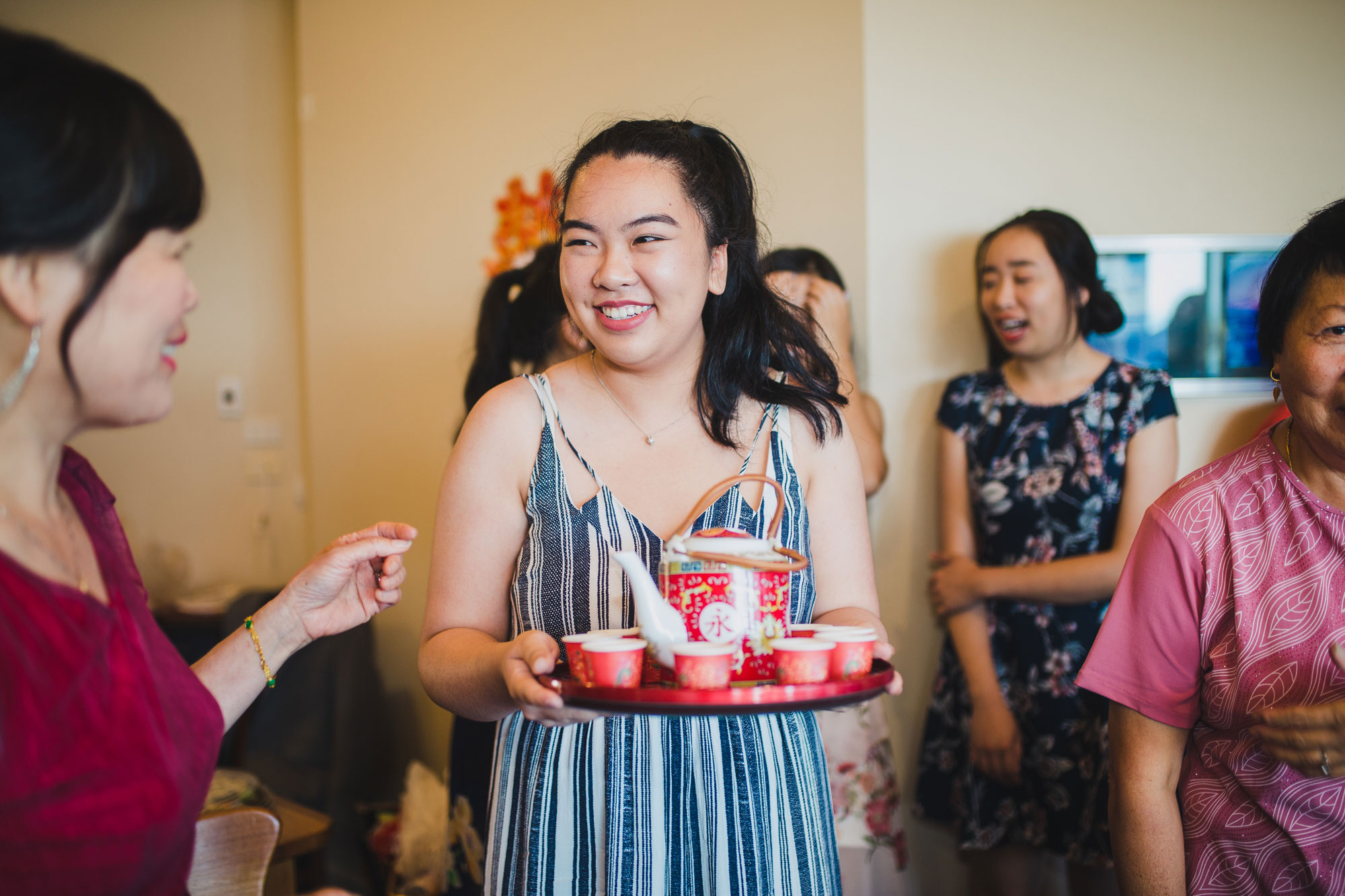 girl holding tea set