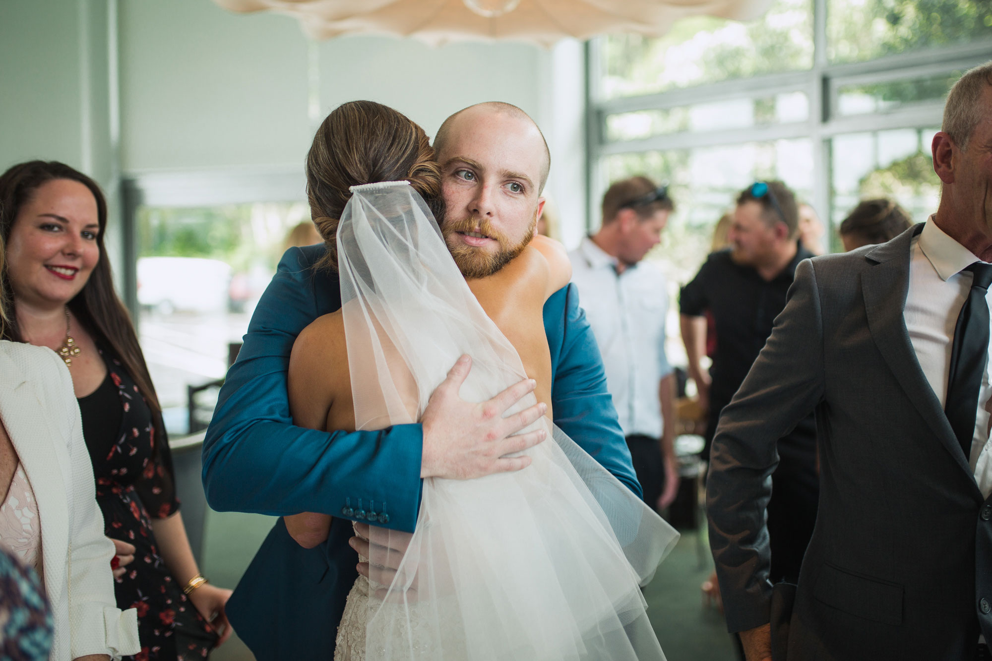 wedding guests hug bride