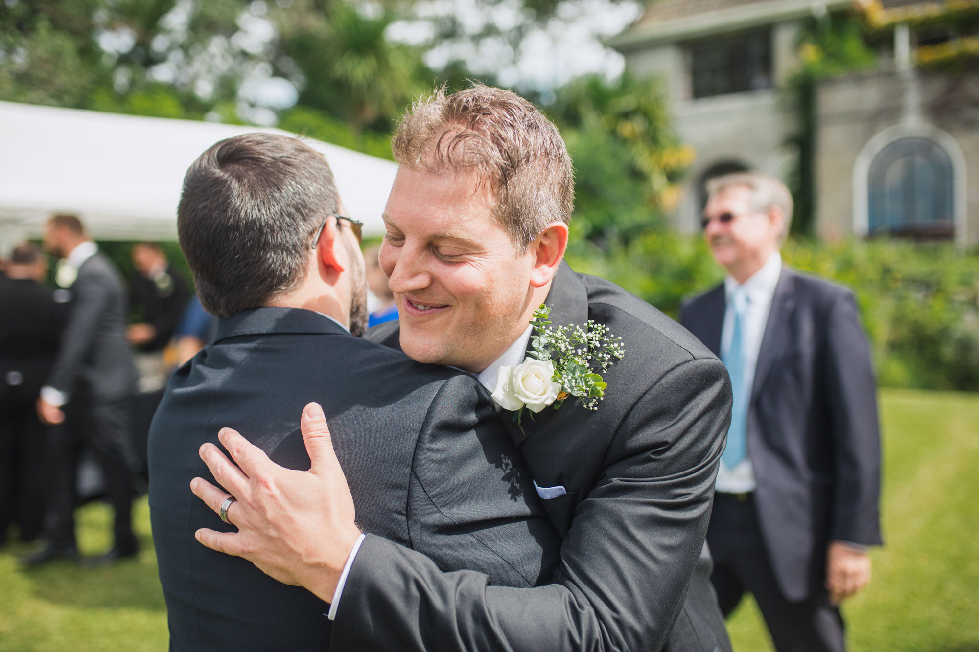 groom hugging guest