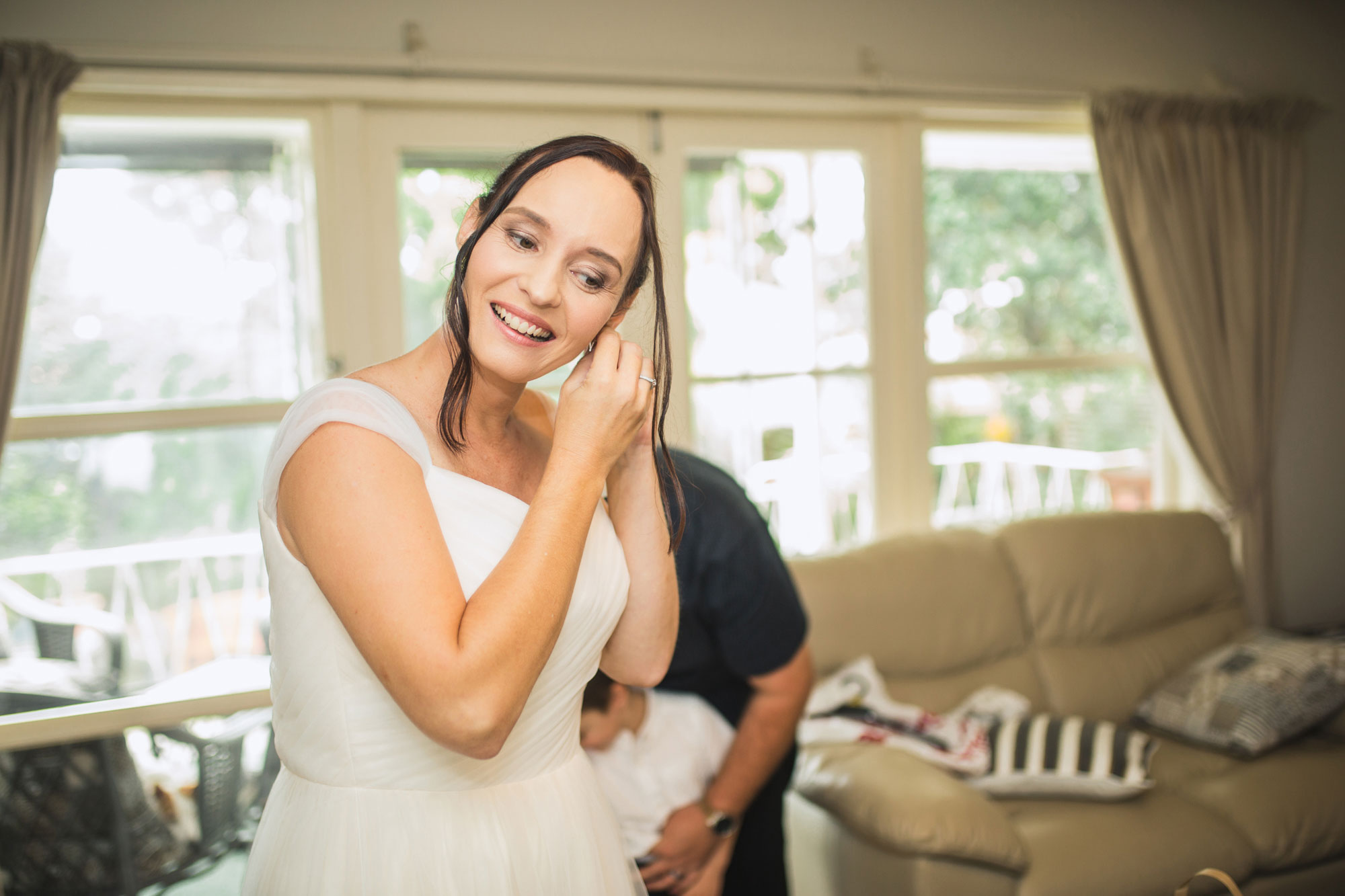 bride putting on earrings