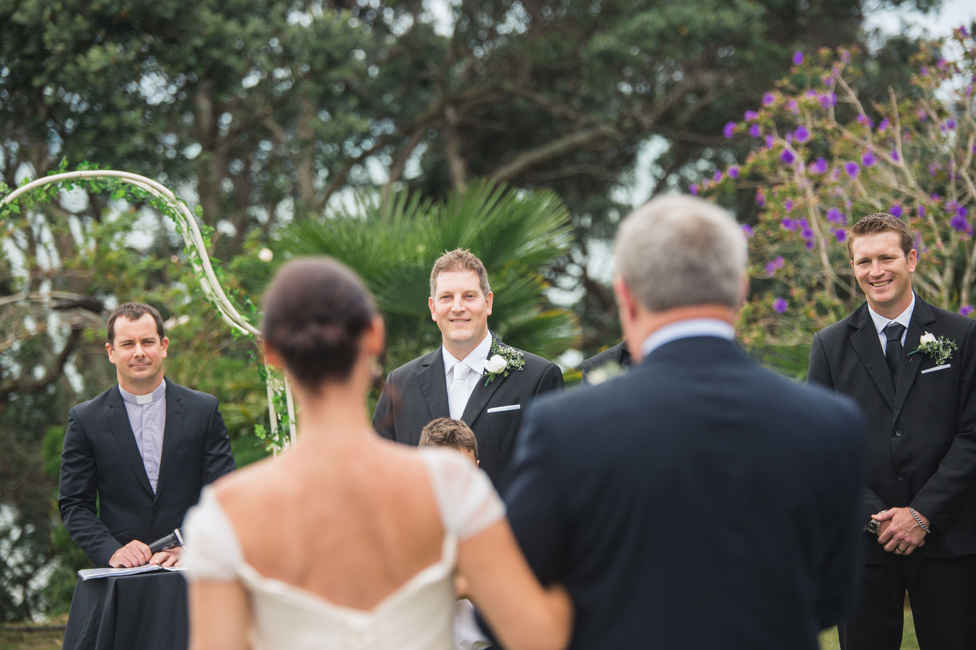 groom looking at the bride