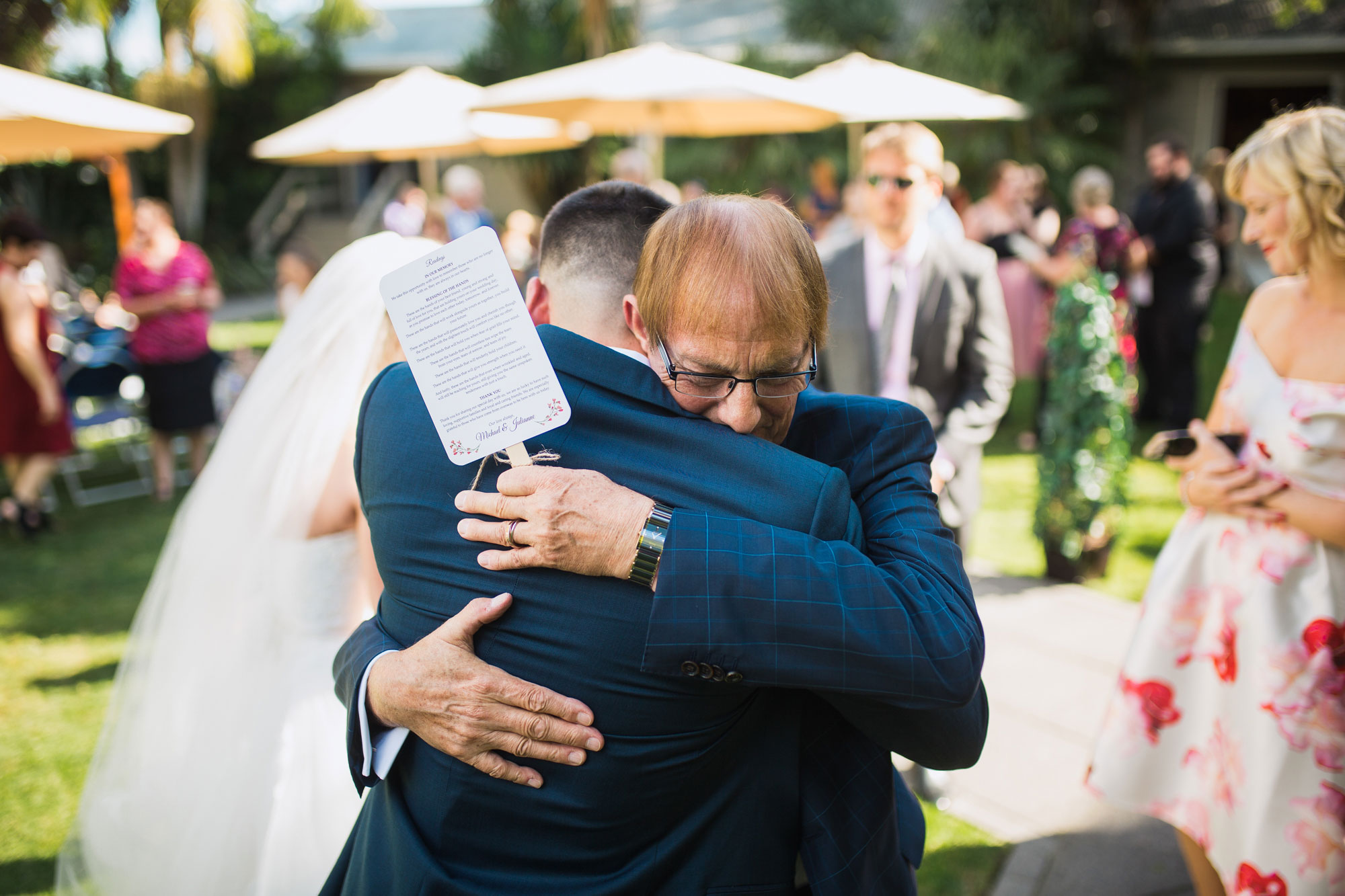 father of the groom hugging